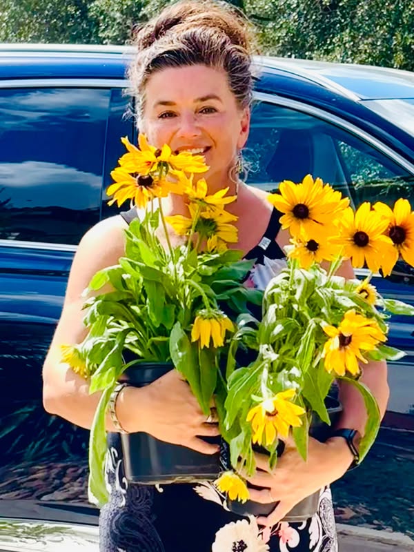 Inna Adamovich holding flower pots.